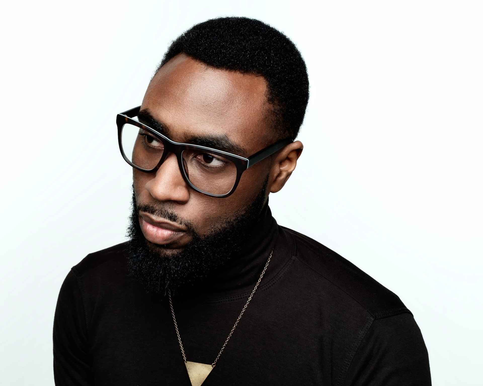 Studio portrait in a black turtleneck by Dan Almasy