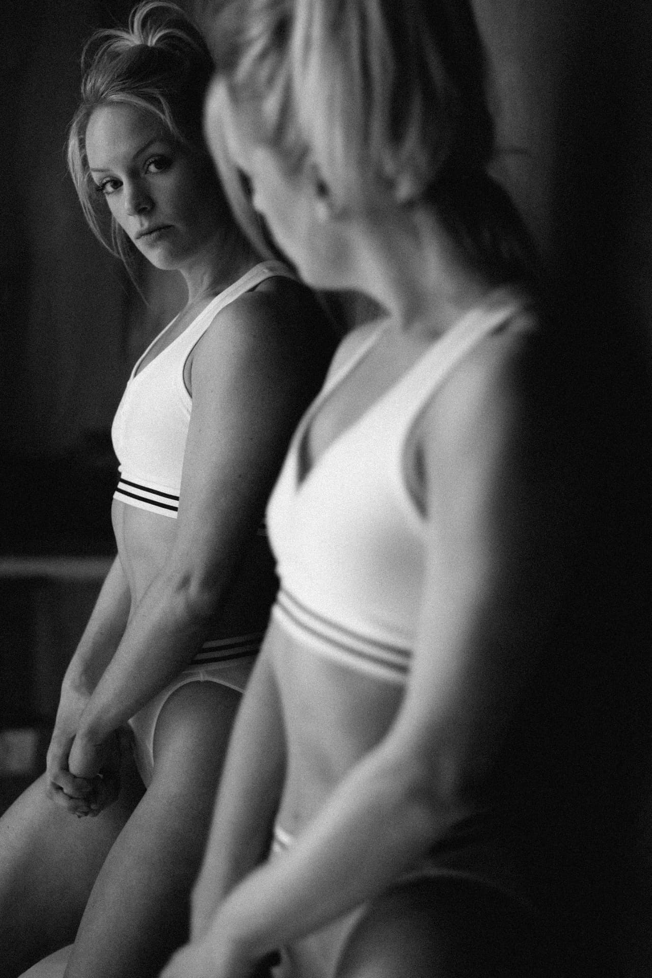 Black and white portrait of two athletes in white activewear by Dan Almasy