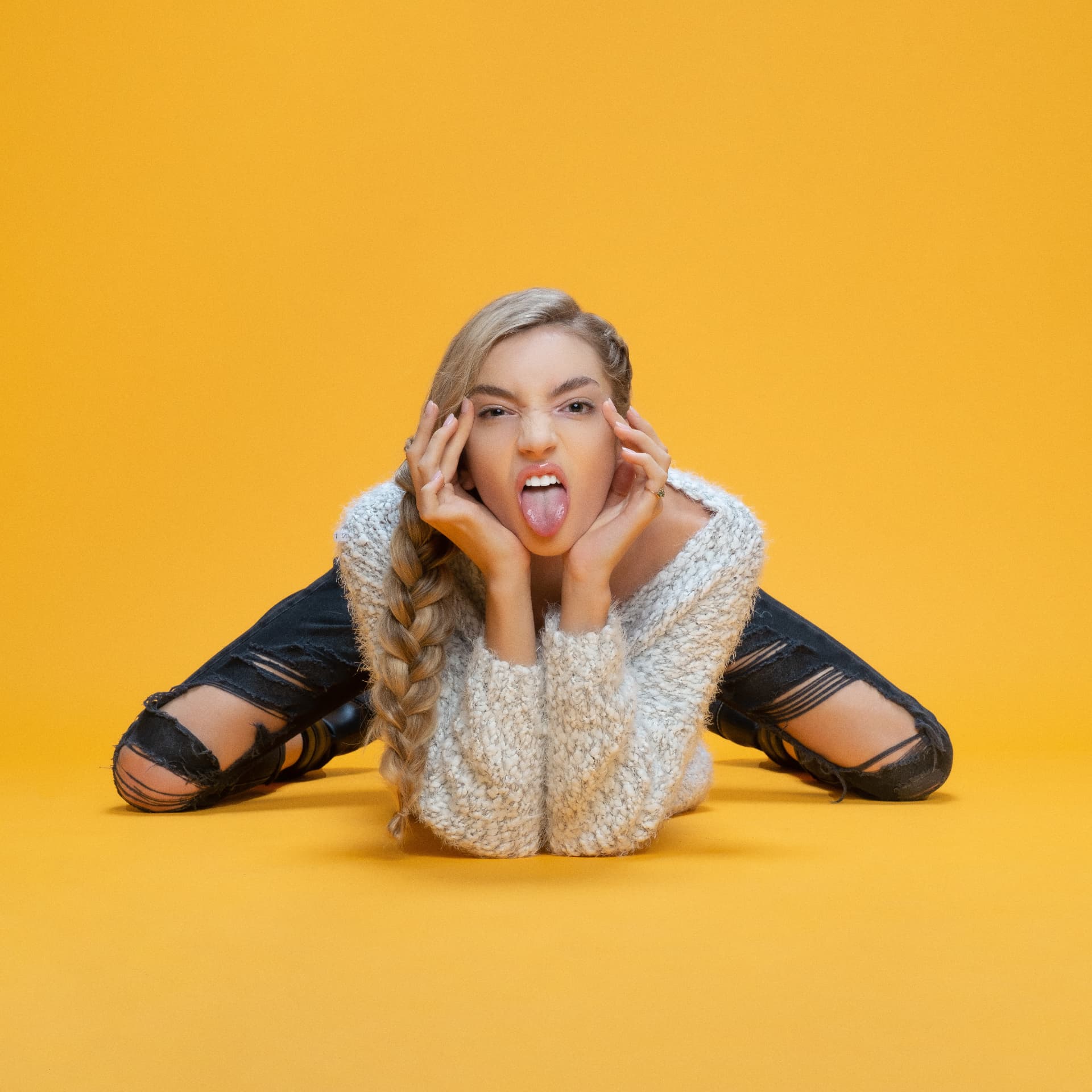 Playful portrait on a bright yellow backdrop by Dan Almasy