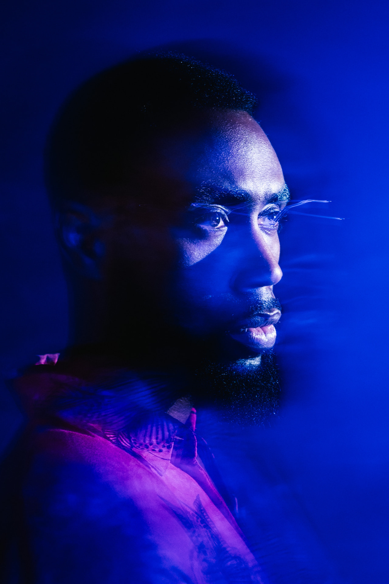 Blue-lit motion-blurred profile portrait by Dan Almasy