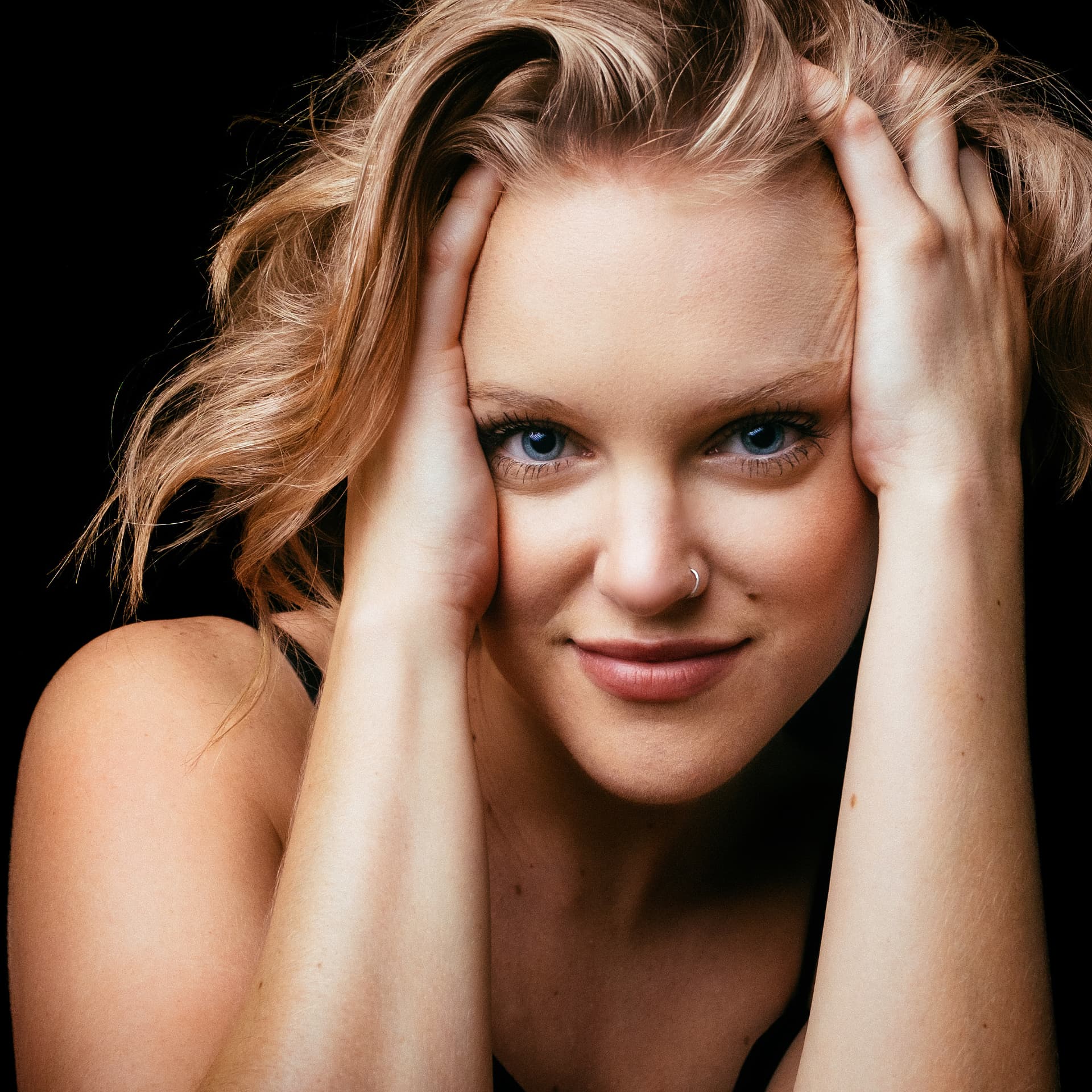 Close-up beauty headshot with hands in the hair by Dan Almasy
