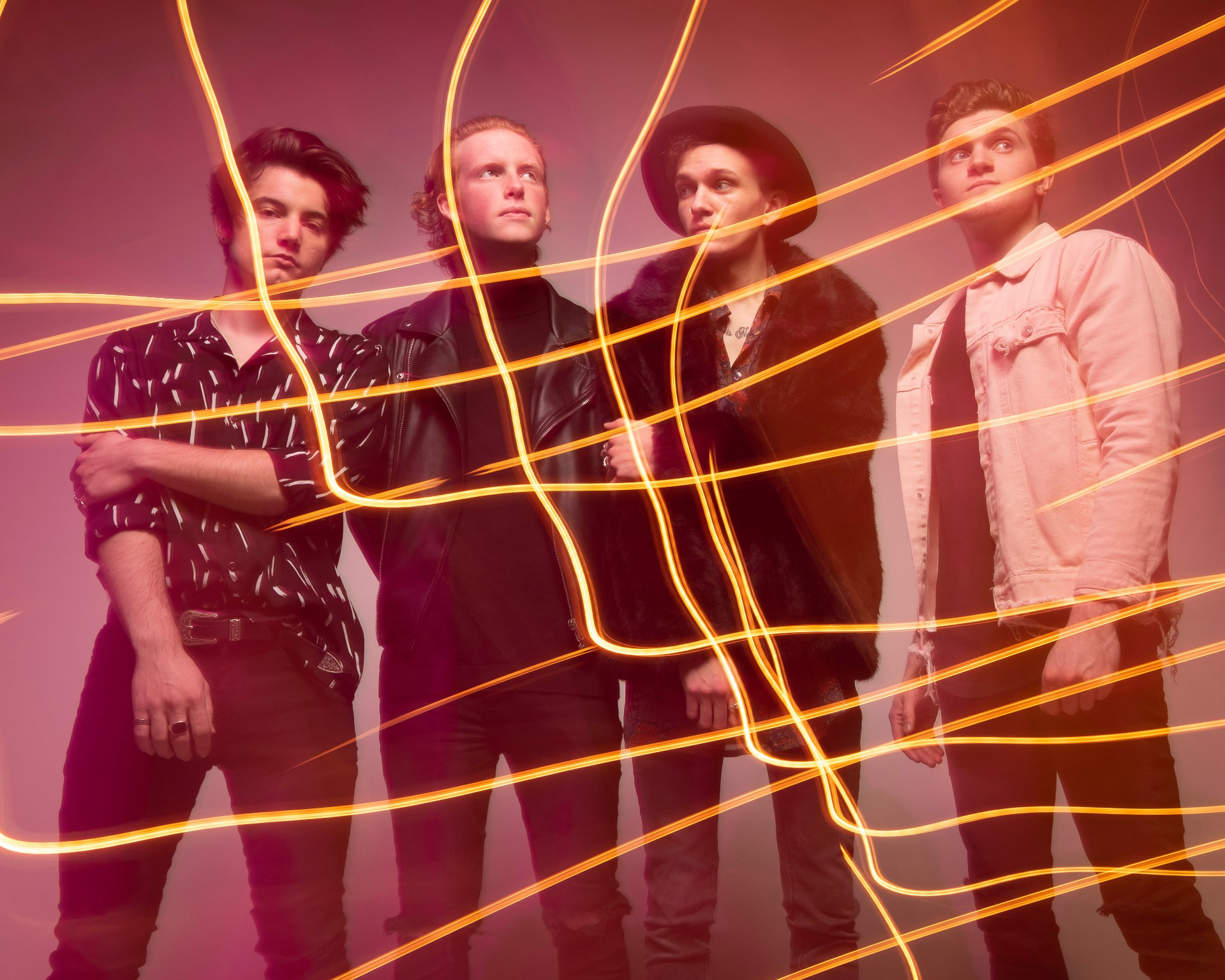 Four-piece band wrapped in orange light trails by Dan Almasy