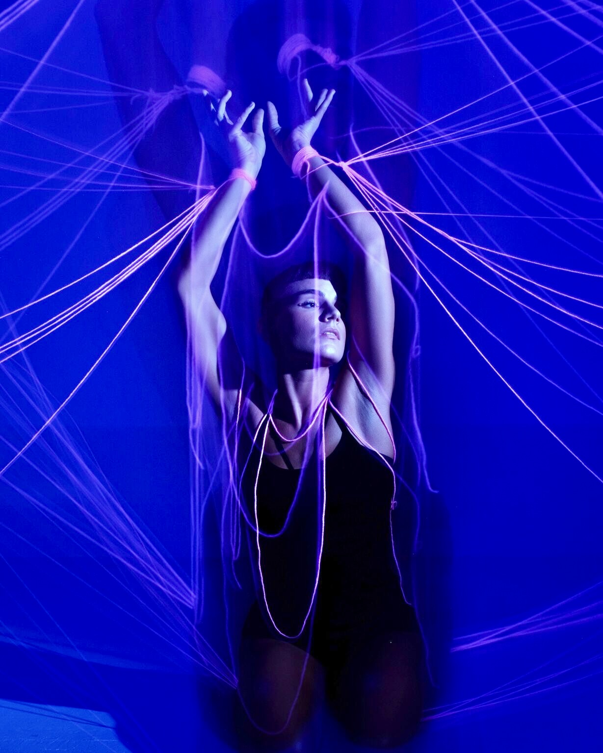 Cobalt-lit dancer with pink light trails by Dan Almasy