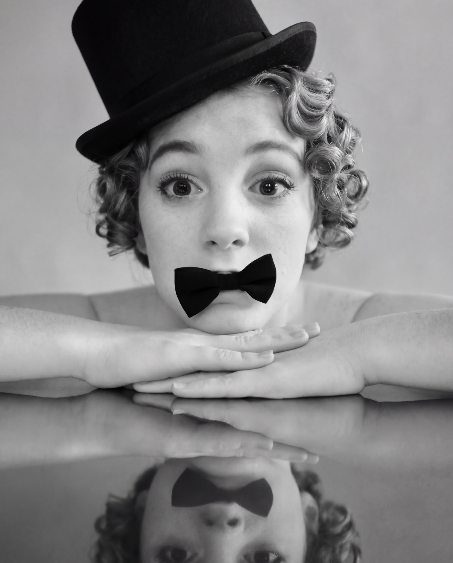 Playful black and white portrait with bowler hat and bow tie by Dan Almasy