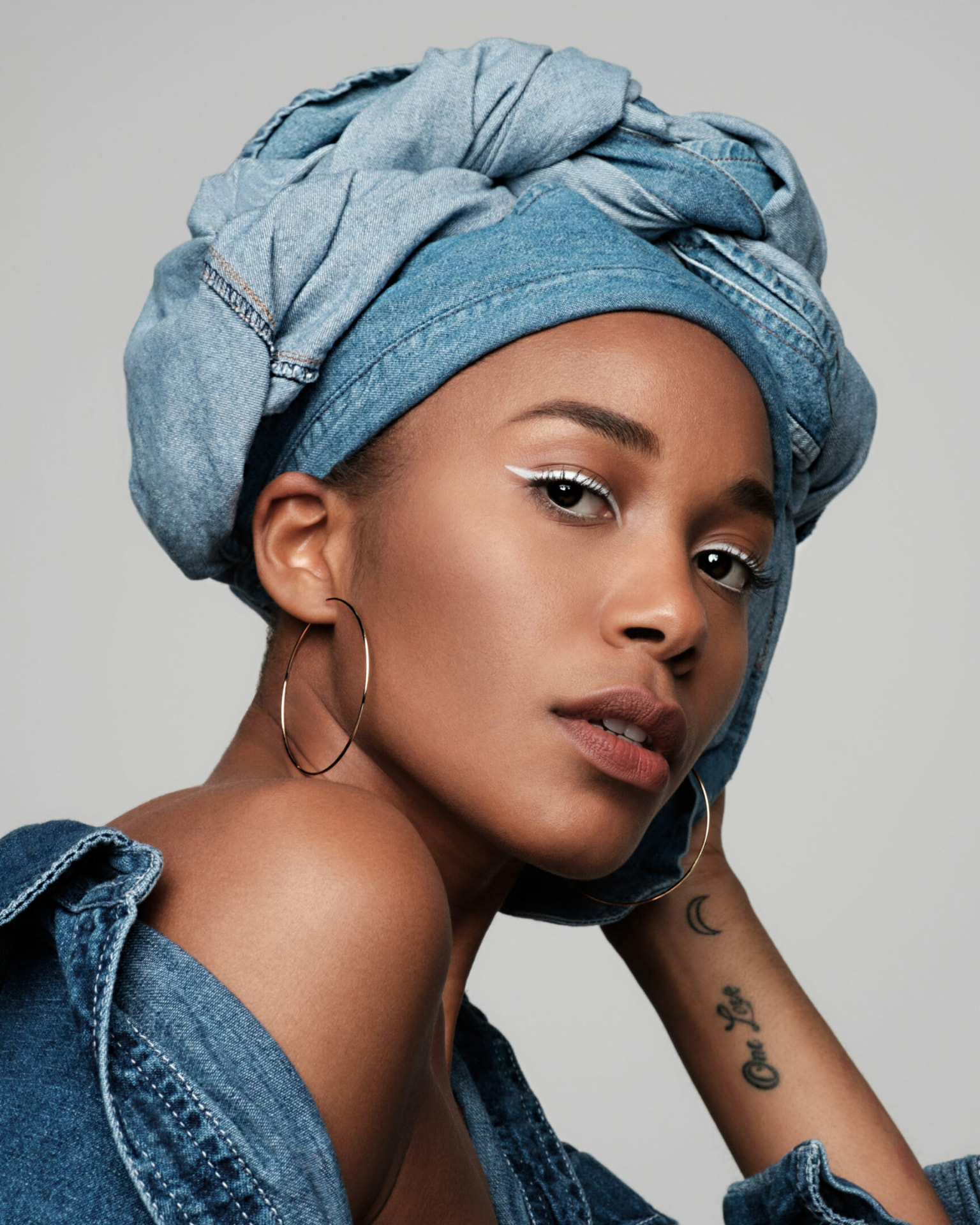 Portrait with denim headwrap and hoop earring by Dan Almasy
