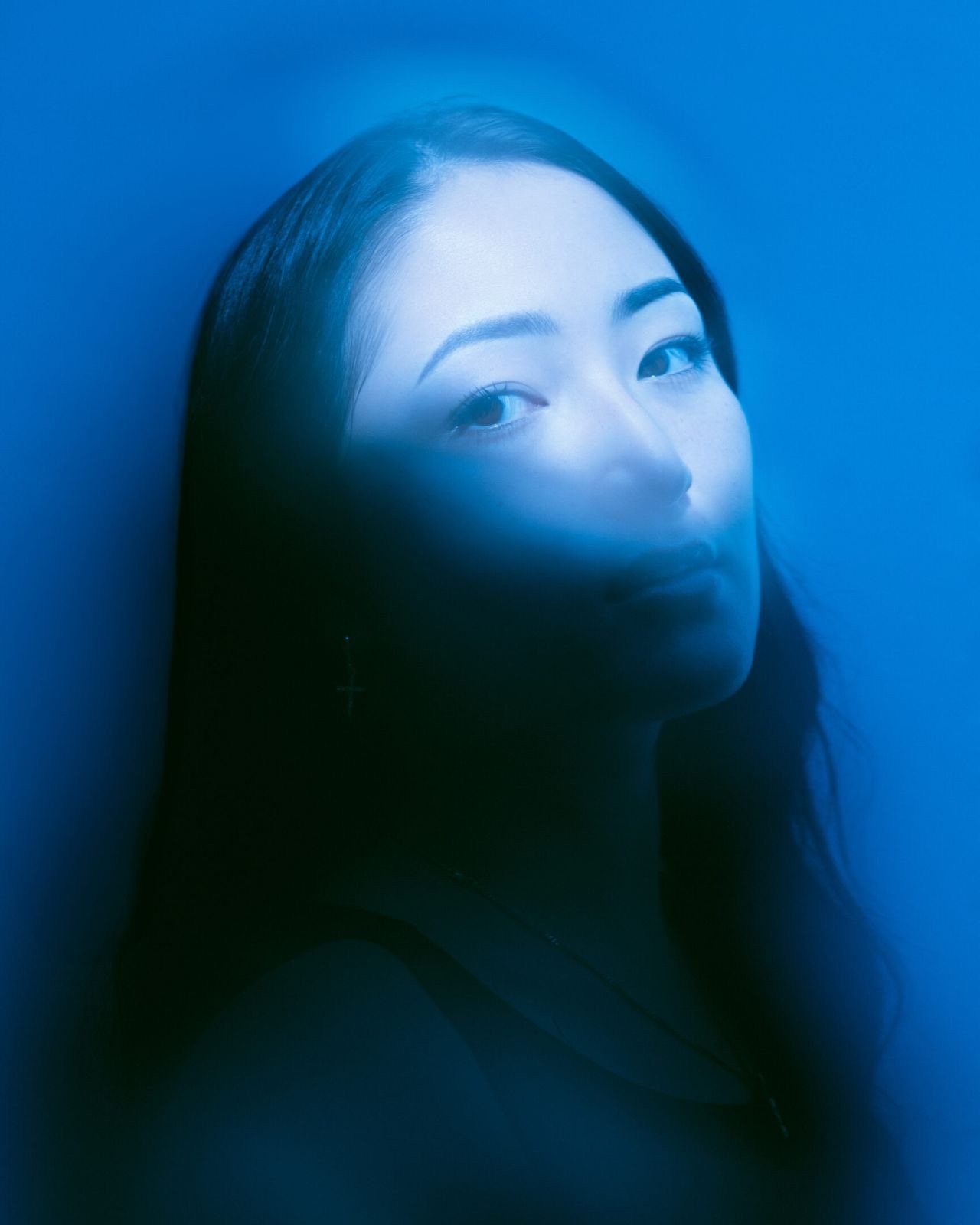 Blue-toned close-up portrait by Dan Almasy