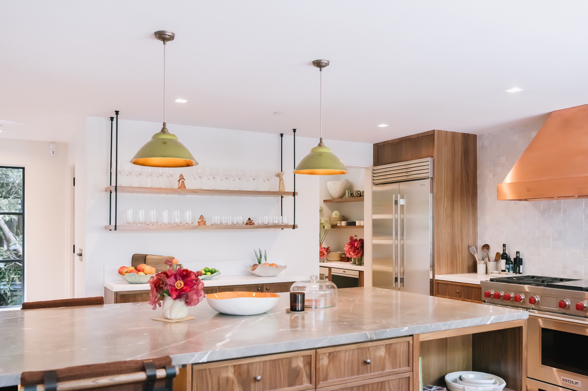 Kitchen with open shelving and copper hood