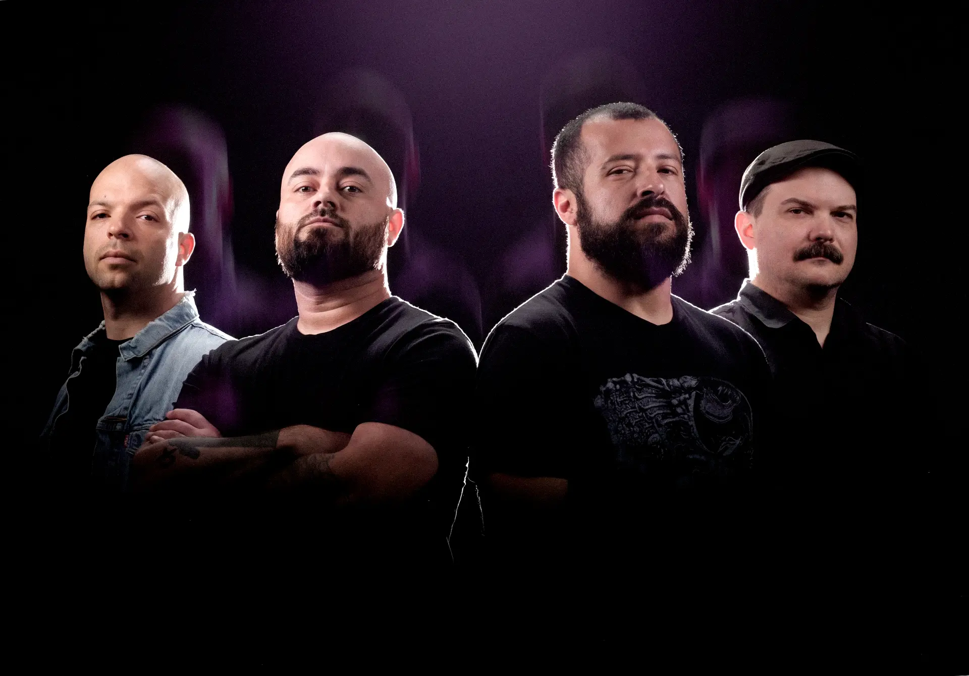 Four-piece band lit with purple rim light by Dan Almasy