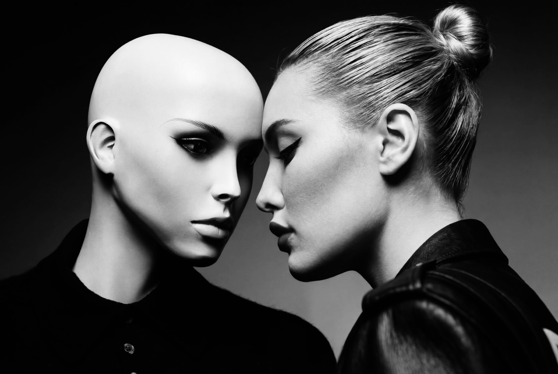 Black and white portrait of a model face to face with a mannequin by Dan Almasy