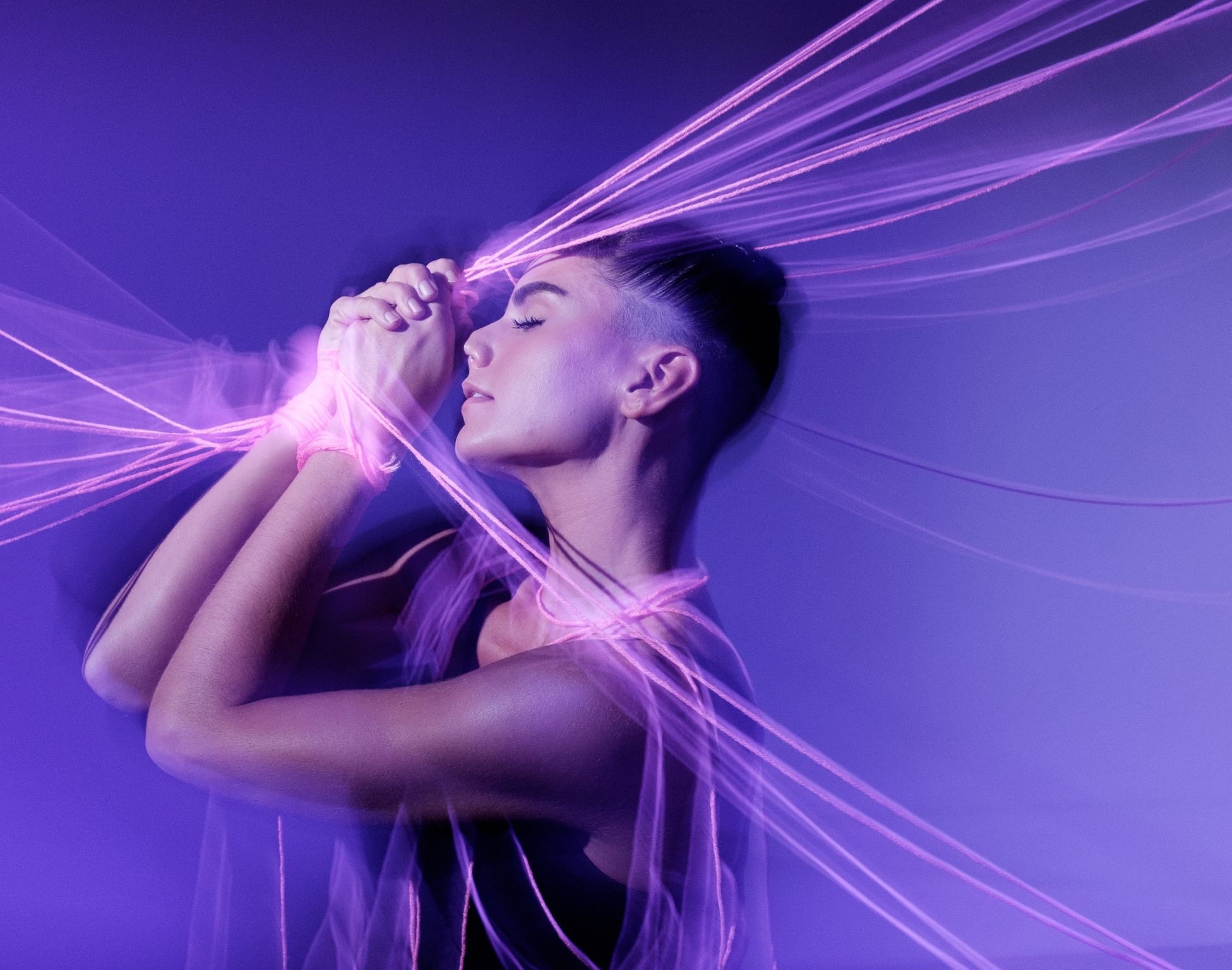 Violet long-exposure portrait wrapped in glowing light trails by Dan Almasy